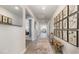 Hallway featuring wood floors, white walls, wall decor, and entrances to multiple rooms at 500 Scarlet Sage Dr., Conway, SC 29527