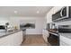 A modern kitchen featuring granite countertops, stainless steel appliances, and wood-style flooring at 500 Scarlet Sage Dr., Conway, SC 29527