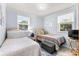 Bright bedroom featuring two beds with wicker headboards and light blue walls at 505 19Th Ave. S, North Myrtle Beach, SC 29582