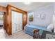 Cozy bedroom with wood-paneled accent wall, built-in storage, and sunny window at 505 19Th Ave. S, North Myrtle Beach, SC 29582