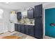 Functional kitchen featuring dark cabinetry, modern appliances, and a convenient washer-dryer setup at 505 19Th Ave. S, North Myrtle Beach, SC 29582