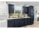A well-equipped kitchen featuring a modern washer-dryer setup, dark cabinets, and a sleek countertop at 505 19Th Ave. S, North Myrtle Beach, SC 29582