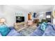 Well-lit living room featuring plush seating, a mounted TV, and seamless transition to the dining and kitchen areas at 505 19Th Ave. S, North Myrtle Beach, SC 29582