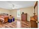 Bedroom features a wood bed frame and hardwood flooring and natural light from a window at 5086 Highway 319 E, Conway, SC 29526
