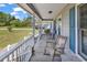 Relax on the inviting front porch with rocking chairs and wood flooring at 5086 Highway 319 E, Conway, SC 29526