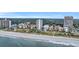 Beautiful aerial view of beachfront condos and resorts along a pristine sandy beach with rolling waves at 5511 N Ocean Blvd. # 203, Myrtle Beach, SC 29577
