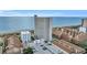 An aerial view of a condo building by the beach and parking areas next to the ocean at 5511 N Ocean Blvd. # 203, Myrtle Beach, SC 29577