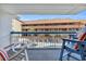 Balcony view overlooking a swimming pool and palm trees in the community at 5511 N Ocean Blvd. # 203, Myrtle Beach, SC 29577