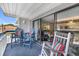 Balcony with views of the living room and rocking chairs with colorful striped pillows at 5511 N Ocean Blvd. # 203, Myrtle Beach, SC 29577
