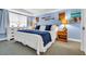 Cozy bedroom featuring a comfortable bed, light blue walls, and wooden furniture at 5511 N Ocean Blvd. # 203, Myrtle Beach, SC 29577
