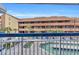 View of the pool and lounge chairs from the balcony in front of a condo building at 5511 N Ocean Blvd. # 203, Myrtle Beach, SC 29577