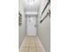 Hallway entryway with decorative oars mounted on the wall and neutral tile flooring at 5511 N Ocean Blvd. # 203, Myrtle Beach, SC 29577