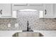 Kitchen sink with tile backsplash and modern black faucet at 5511 N Ocean Blvd. # 203, Myrtle Beach, SC 29577