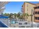 Outdoor pool area with lounge chairs and palm trees, perfect for relaxing at 5511 N Ocean Blvd. # 203, Myrtle Beach, SC 29577