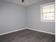 Neutral-colored bedroom featuring wood floors and a window allowing natural light to fill the room at 573 Blue River Ct. # 8-H, Myrtle Beach, SC 29579