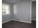 Bedroom with wood floors, window overlooking exterior greenery and neutral wall color at 573 Blue River Ct. # 8-H, Myrtle Beach, SC 29579
