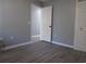 Bedroom with wood floors, neutral walls, and a white door to an adjacent room at 573 Blue River Ct. # 8-H, Myrtle Beach, SC 29579