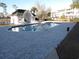 Inviting community pool with a bath house, surrounded by a brick paver deck and lush landscaping at 573 Blue River Ct. # 8-H, Myrtle Beach, SC 29579