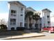 Inviting condo building featuring multiple floors, private balconies, and well-maintained landscaping at 573 Blue River Ct. # 8-H, Myrtle Beach, SC 29579