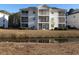 Serene condo building with screened porches and a scenic view of a reflective waterway at 573 Blue River Ct. # 8-H, Myrtle Beach, SC 29579