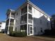 Well-maintained condo building with spacious screened porches and lush landscaping for outdoor living at 573 Blue River Ct. # 8-H, Myrtle Beach, SC 29579