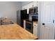 Well-lit kitchen featuring butcher block countertops, stainless steel appliances and white cabinetry at 573 Blue River Ct. # 8-H, Myrtle Beach, SC 29579