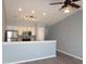 Bright kitchen includes stainless steel appliances, track lighting, and white cabinetry, open to the living area at 573 Blue River Ct. # 8-H, Myrtle Beach, SC 29579