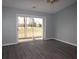 Living room with sliding glass door to exterior porch and golf course views at 573 Blue River Ct. # 8-H, Myrtle Beach, SC 29579