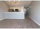 A modern living room adjacent to the kitchen features vinyl flooring, neutral paint, and recessed and track lighting at 573 Blue River Ct. # 8-H, Myrtle Beach, SC 29579