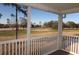 A serene view from the private patio overlooking a lush golf course, with mature trees and blue skies at 573 Blue River Ct. # 8-H, Myrtle Beach, SC 29579