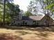 Back exterior view of house featuring patio area, well maintained lawn and landscaping at 9500 Indigo Creek Blvd., Murrells Inlet, SC 29576