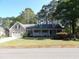 Charming home with a manicured lawn, inviting front porch, and attached two-car garage at 9500 Indigo Creek Blvd., Murrells Inlet, SC 29576