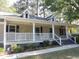 Inviting front porch with decorative white railings, providing a charming and welcoming entrance at 9500 Indigo Creek Blvd., Murrells Inlet, SC 29576