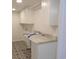 Well lit Laundry room with geometric floor tiling, granite countertop, and storage cabinets at 9500 Indigo Creek Blvd., Murrells Inlet, SC 29576