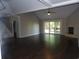 Open-concept living room featuring vaulted ceilings, fireplace, and glass doors at 9500 Indigo Creek Blvd., Murrells Inlet, SC 29576
