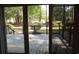View of the wooden patio and green space through sliding glass doors at 9500 Indigo Creek Blvd., Murrells Inlet, SC 29576