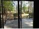 Outdoor deck overlooking the landscaped backyard with mature trees at 9500 Indigo Creek Blvd., Murrells Inlet, SC 29576
