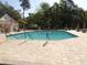 Large community pool with an outdoor seating area and lush trees in the background at 9500 Indigo Creek Blvd., Murrells Inlet, SC 29576