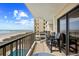 Balcony with ocean views, pool access, and comfortable seating, perfect for outdoor relaxation at 6200 N Ocean Blvd. # 203, North Myrtle Beach, SC 29582