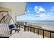 Balcony with comfortable seating offering panoramic ocean views, creating a serene outdoor space for relaxation at 6200 N Ocean Blvd. # 203, North Myrtle Beach, SC 29582