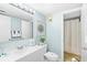 Bright bathroom features a single vanity, toilet and tiled shower with shower curtain at 6200 N Ocean Blvd. # 203, North Myrtle Beach, SC 29582