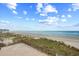 Beautiful ocean view from a balcony, showcasing a sandy beach and clear skies at 6200 N Ocean Blvd. # 203, North Myrtle Beach, SC 29582