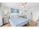 Bright bedroom features a light blue bed set, light walls, ceiling fan, and art on the wall at 6200 N Ocean Blvd. # 203, North Myrtle Beach, SC 29582