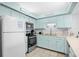 Bright kitchen featuring blue cabinets, stainless steel appliances, and ample counter space at 6200 N Ocean Blvd. # 203, North Myrtle Beach, SC 29582