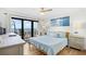 Cozy main bedroom features a comfortable bed and access to a private balcony with stunning ocean views at 6200 N Ocean Blvd. # 203, North Myrtle Beach, SC 29582
