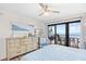Main bedroom features balcony access, dresser, TV, and comfortable decor at 6200 N Ocean Blvd. # 203, North Myrtle Beach, SC 29582