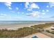Stunning ocean view with a pier, sandy beach, and clear skies from a balcony at 6200 N Ocean Blvd. # 203, North Myrtle Beach, SC 29582