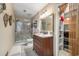 Well-lit bathroom featuring a shower, vanity with a marble countertop, and closet at 634 Melody Ln., Surfside Beach, SC 29575
