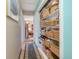 Hallway leading to a bedroom and closet with ample shelving at 634 Melody Ln., Surfside Beach, SC 29575