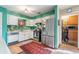 Well-lit kitchen featuring stainless steel appliances, white cabinets, and ample counter space at 634 Melody Ln., Surfside Beach, SC 29575